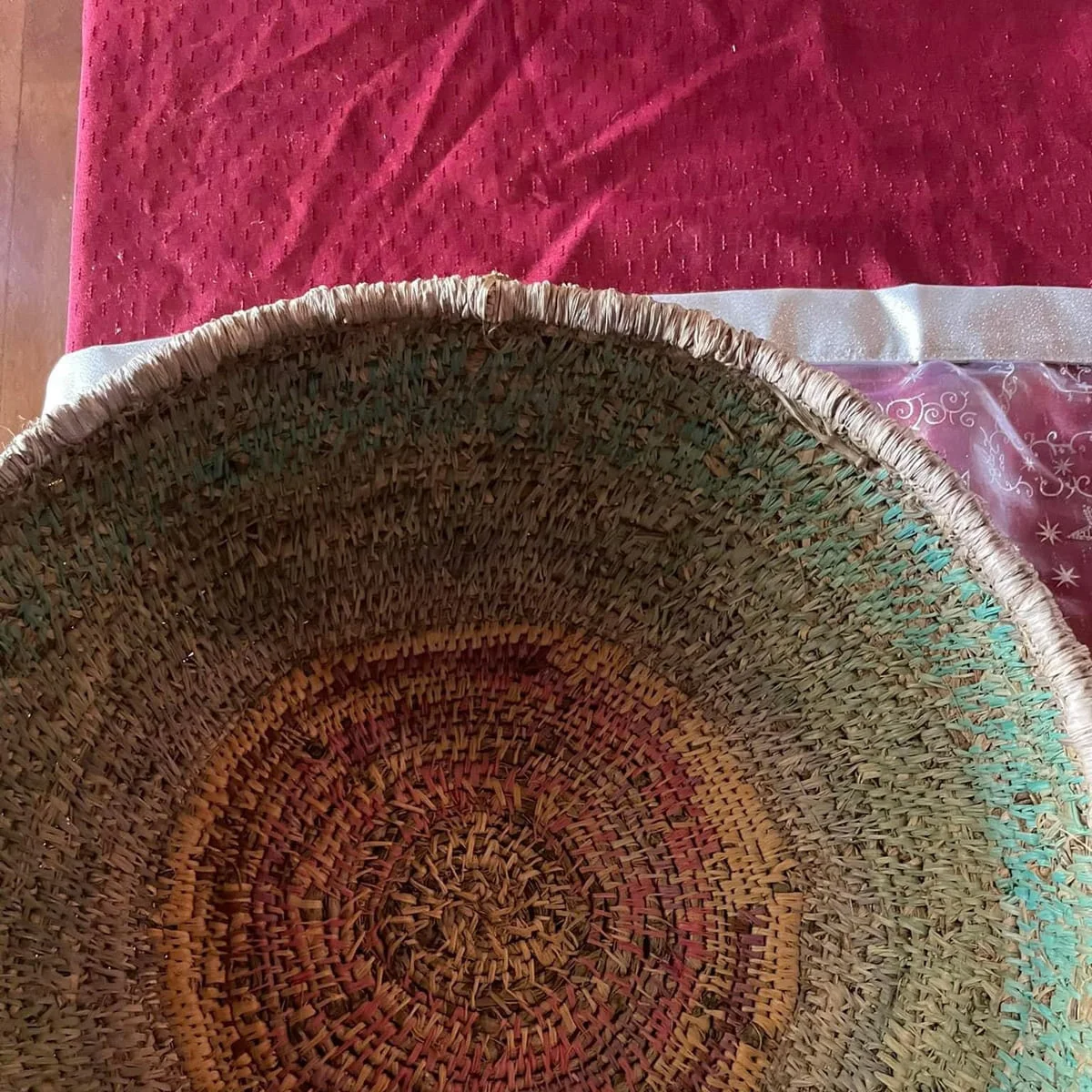 Looking into a coiled basket with a spiral base in rust and green